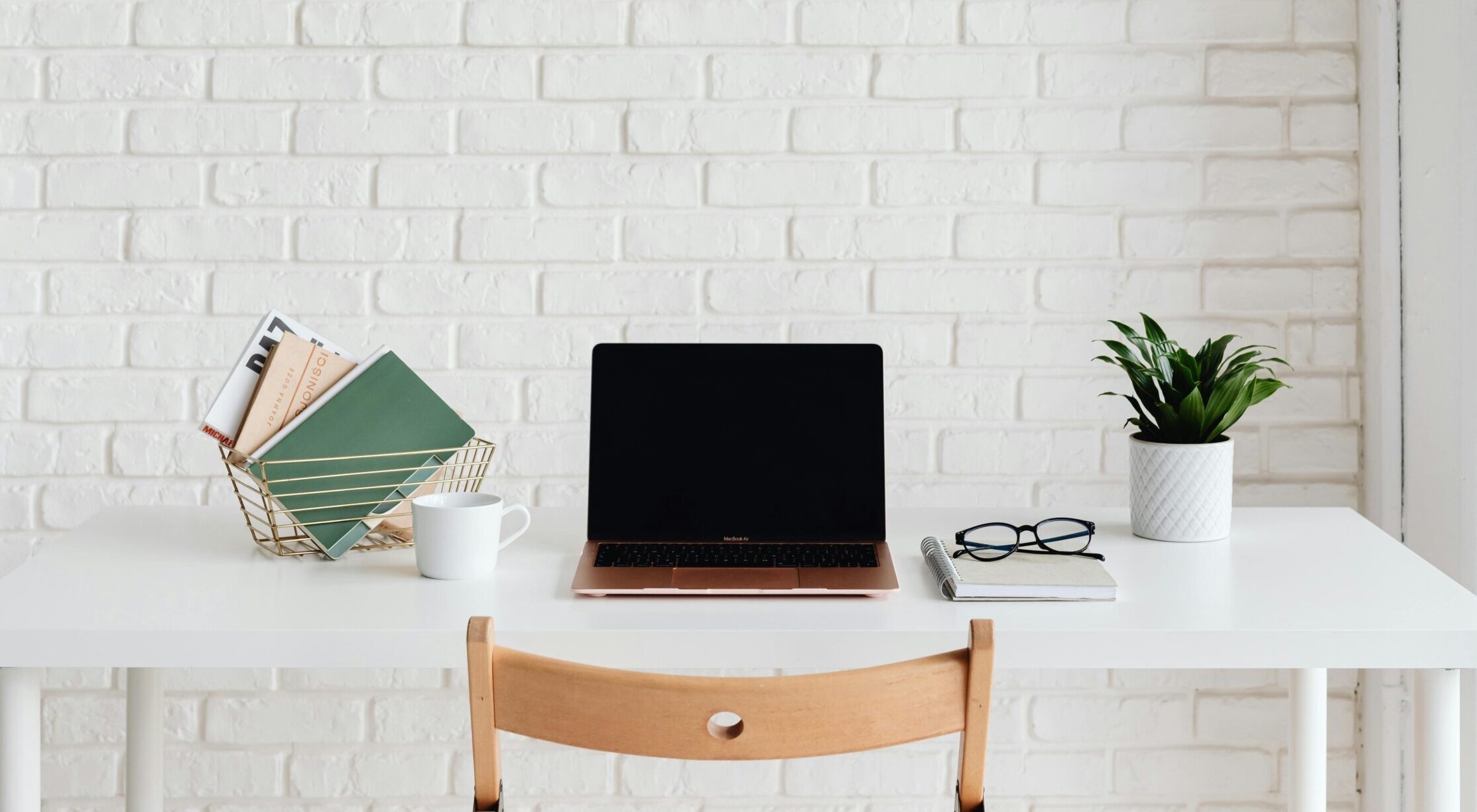 Organizing your day, laptop and notebooks on a desk.